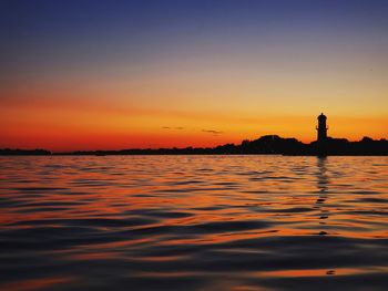 Scenic view of sea against romantic sky at sunset