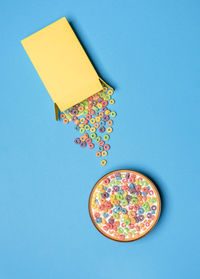 Directly above shot of multi colored candies against blue background