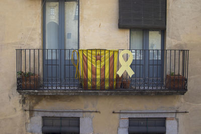 Buildings displaying the catalan flag in girona, spain