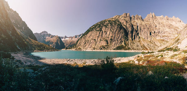 Scenic view of lake and mountains against clear sky