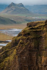 Scenic view of sea and mountains against sky