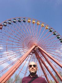 Low angle view of ferris wheel against clear sky