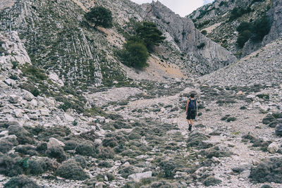 Woman hiking on a mountain path in catalonia on a cloudy summer day