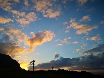 Low angle view of silhouette person standing against sky during sunset