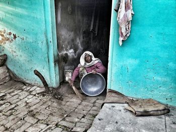 High angle view of woman cleaning on doorway