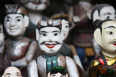 Close-up of wooden puppets for sale at market stall