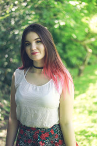 Young woman walking on field in park