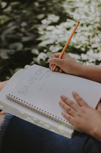 Girl hand writing in the park