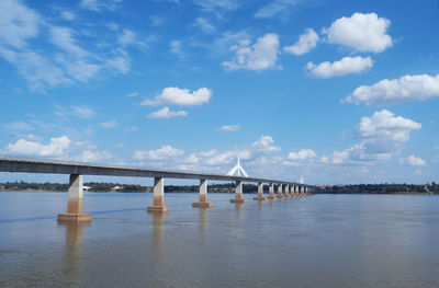 Low angle view of bridge over river against sky