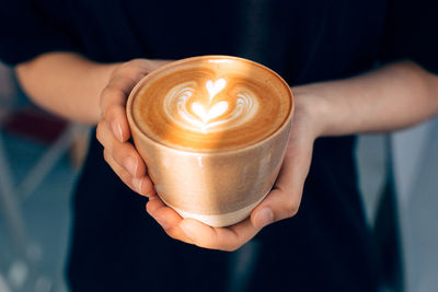 Close-up of coffee cup with heart shape