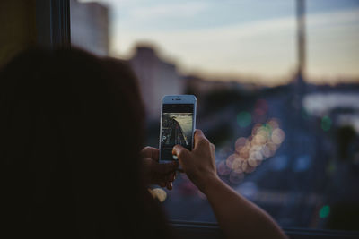 Close-up of hands photographing with mobile phone