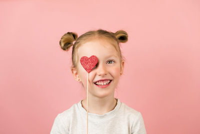 Portrait of woman wearing mask against wall