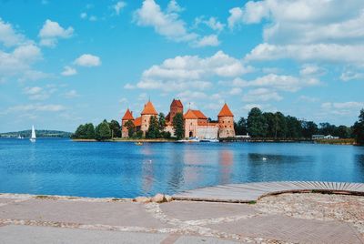 Trakai island castle by lake galve against sky