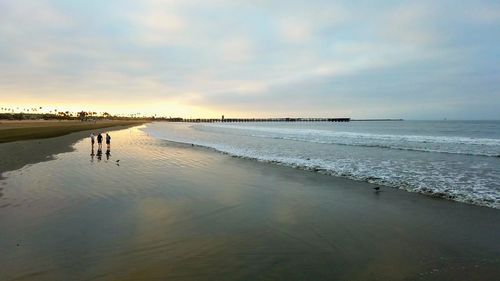 Scenic view of beach against sky during sunset