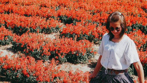 Young woman standing amidst plants