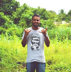 Portrait of smiling young man standing on land