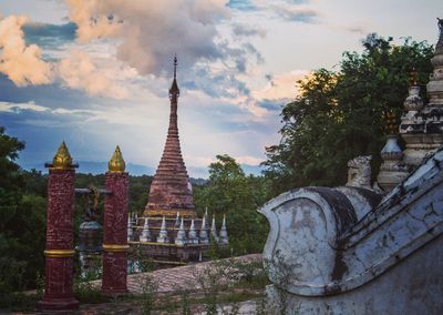 Statue of temple against cloudy sky