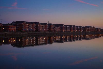 Reflection of illuminated buildings in water at night