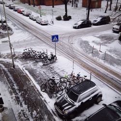 Cars and bicycles on snow covered road