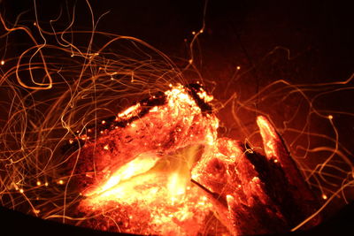 Illuminated sparks in bonfire