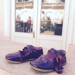 Close-up of purple shoes on retaining wall