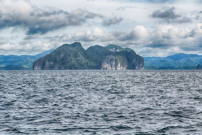 Scenic view of sea and mountains against sky