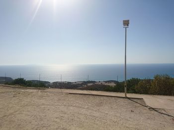 View of calm beach against clear sky