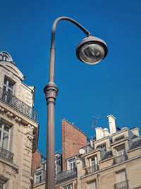 Low angle view of buildings against clear blue sky