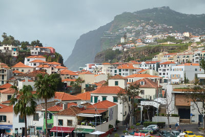 Buildings in town against sky