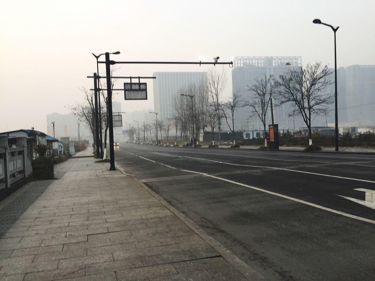 street light, the way forward, building exterior, built structure, transportation, street, architecture, road, clear sky, empty, sky, road marking, city, sidewalk, diminishing perspective, car, outdoors, vanishing point, day, incidental people