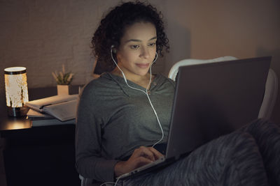 Portrait of young woman using mobile phone