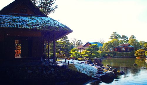 Close-up of amusement park by swimming pool against sky