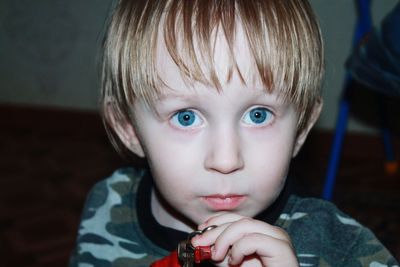 Close-up of portrait of boy with blue eyes