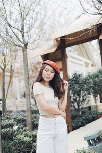 Thoughtful young woman wearing flat cap in park