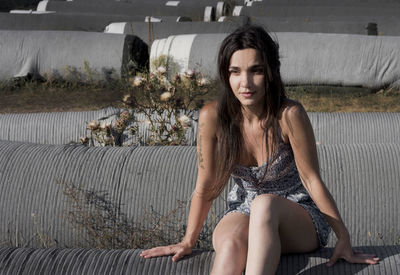 Portrait of young woman sitting on sofa