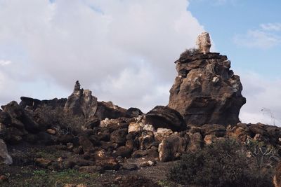 Stack of rock formations on landscape against sky