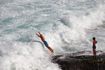 High angle view of man surfing in sea