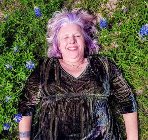 High angle view of smiling woman relaxing on field