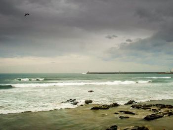 Scenic view of sea against cloudy sky