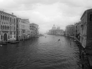 Canal passing through buildings in city