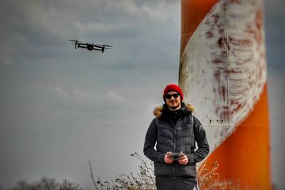 Low angle view of man standing against sky