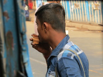 Portrait of young man smoking cigarette