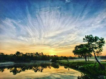 Scenic view of lake against sky during sunset