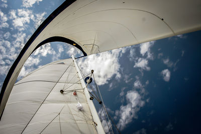Low angle view of boat canvas against blue sky