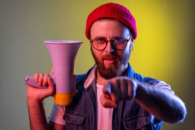 Portrait of man holding megaphone