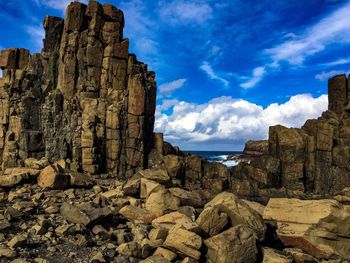 Low angle view of rock formation against sky