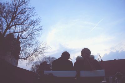 Low angle view of bare trees against blue sky