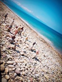 Close-up of pebbles on beach against sky