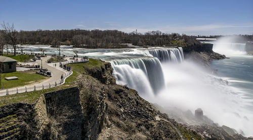 Scenic view of waterfall against sky
