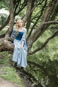 Young woman standing in forest